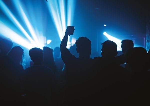 Silhouette of people at a music event.