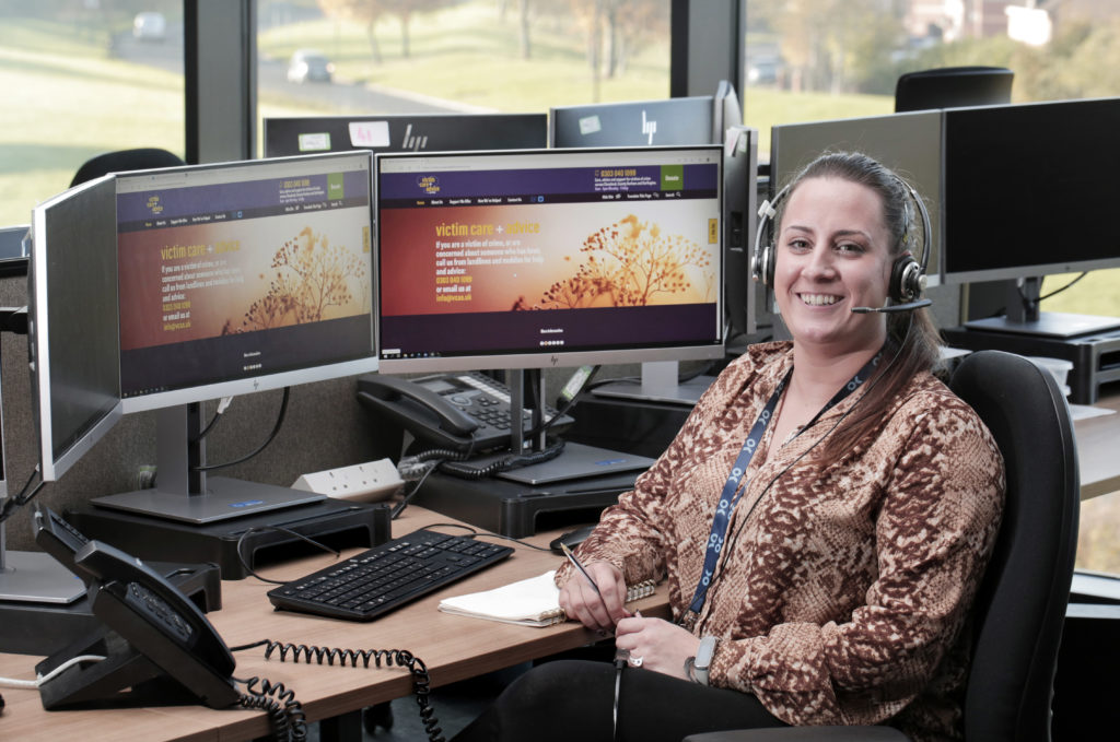 Victim Care Officer Sam Harrison sat at a computer in police control room