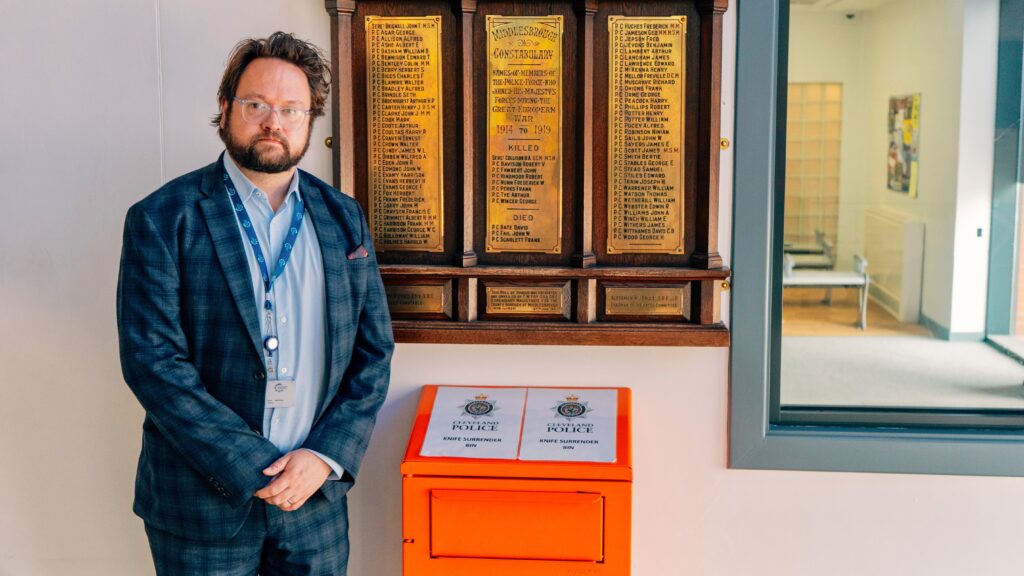 PCC Matt Storey stood next to an orange knife surrender bin.