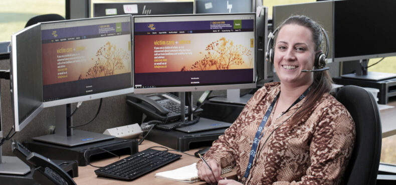 Victim Care Officer Sam Harrison sat at a computer in police control room