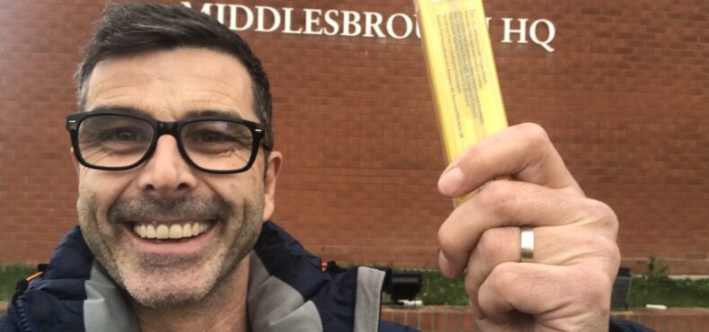 George Charlton is holding up a lifesaving Naloxoner kit outside Middlesbrough Police Station