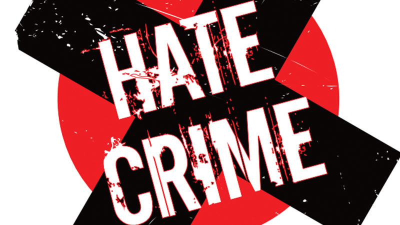 Hate Crime logo with a black cross on a red circle.