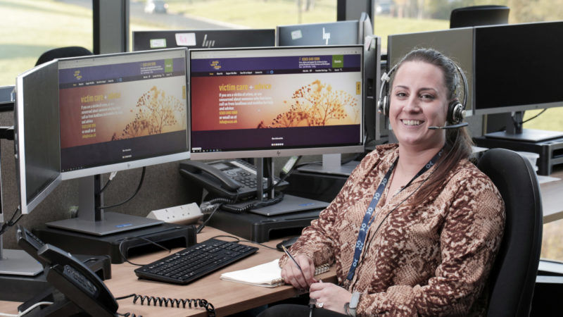 Victim Care Officer Sam Harrison sat at a computer in police control room